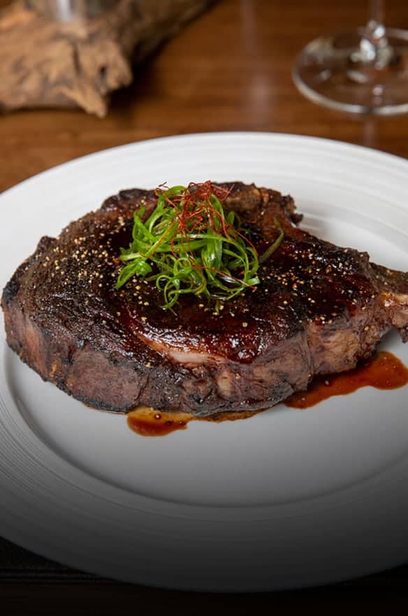 Japanese wagyu steak with miso glaze, black garlic butter, seaweed, and sesame garnish