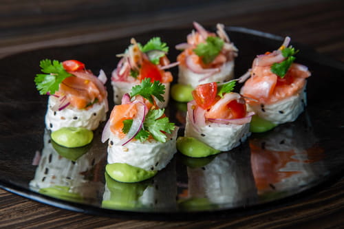 King salmon ceviche sushi rolls with avocado, tomato, cilantro, onion, Asian pear, and ume vinaigrette from Bellevue sushi bar