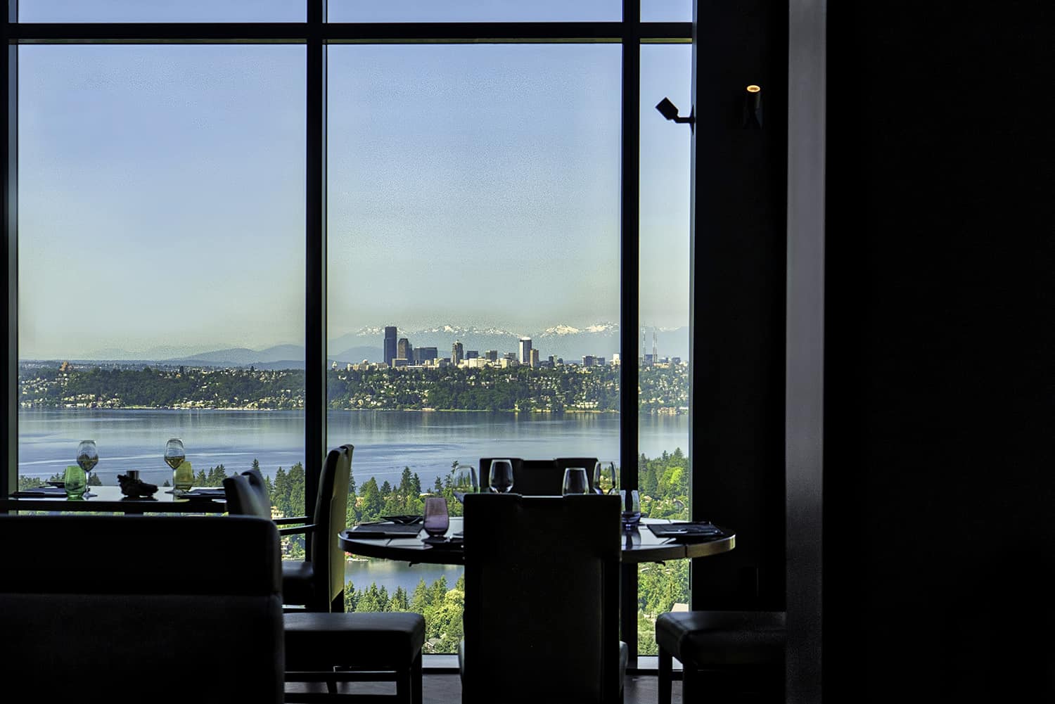 Bellevue fine dining restaurant overlooking Seattle and Lake Washington with wine glasses at tables