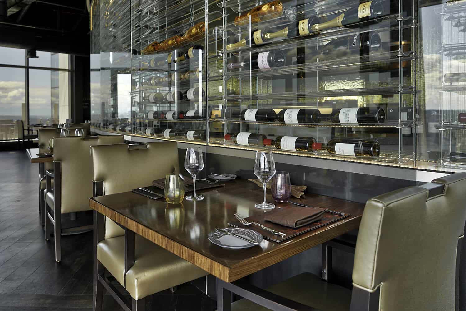 Downtown Bellevue fine dining restaurant with vintage wine display and view of city