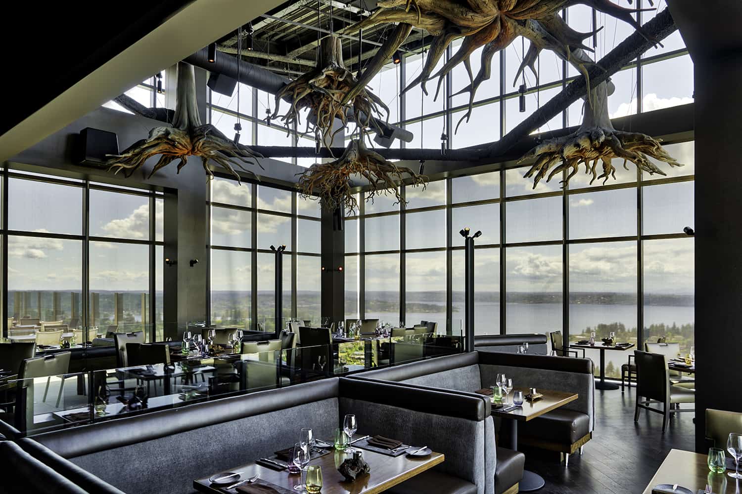 Bellevue steakhouse dining room with spacious seating overlooking bay and cityscape from 31st floor