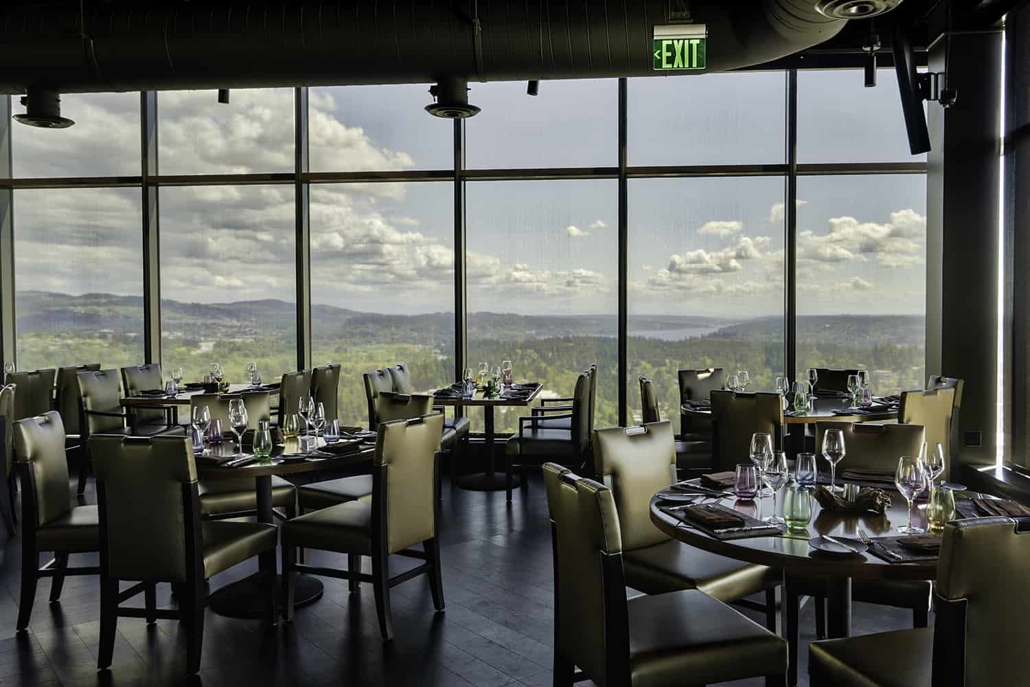 Seating at Bellevue fine dining restaurant with view of wilderness from 31st floor