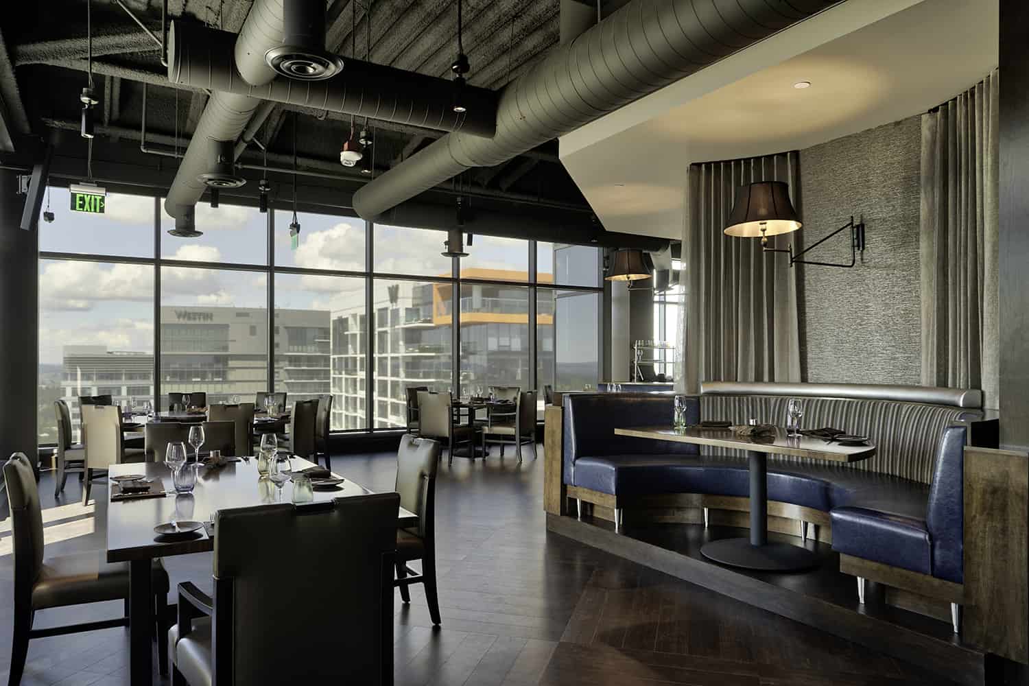 Bellevue fine dining restaurant with booths and spacious tables with view of city from high floor