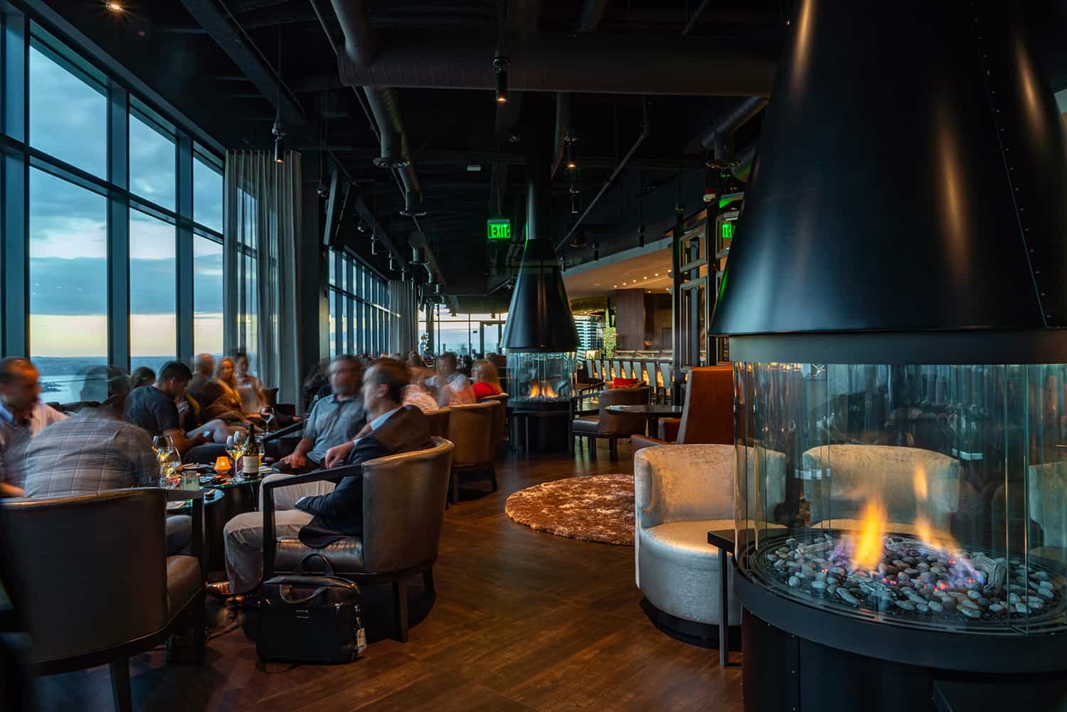 Bellevue steakhouse lounge with fireplaces and patrons enjoying fine wine