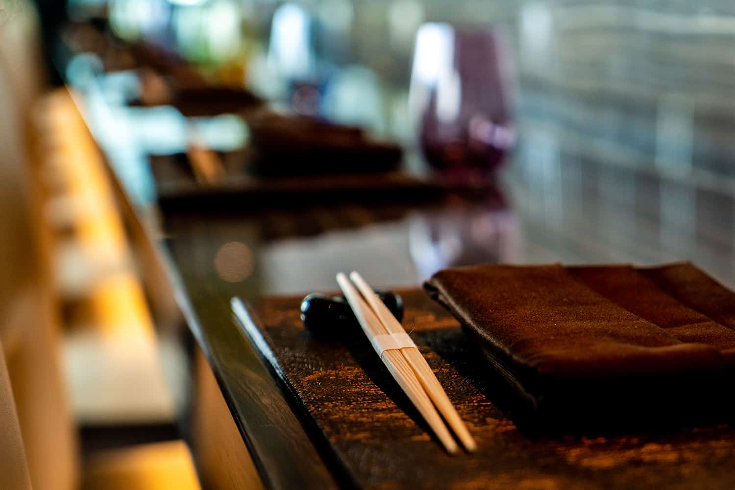 High end sushi bar in Bellevue, WA with table settings on marble slabs