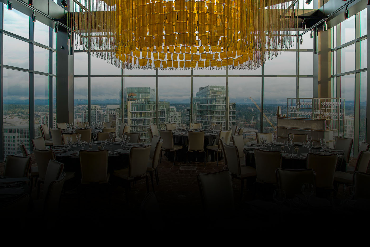 Bellevue steakhouse private dining suite with view of city from 31st floor and large chandelier