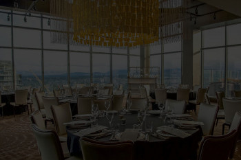 Bellevue private event room with circular tables and large decorative chandelier